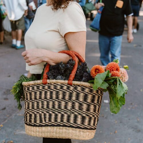 Lady in market with oval African woven basket