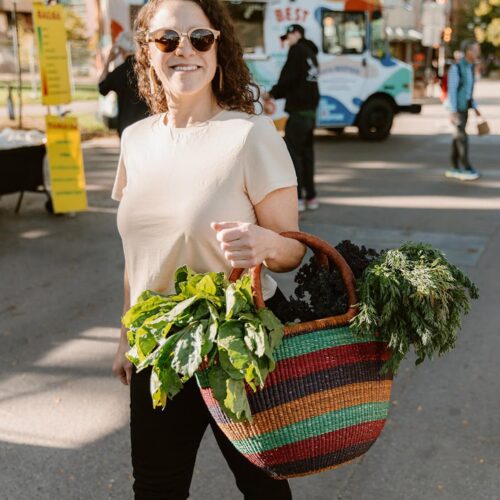 Woman in Farmers market with colorful shopping tote