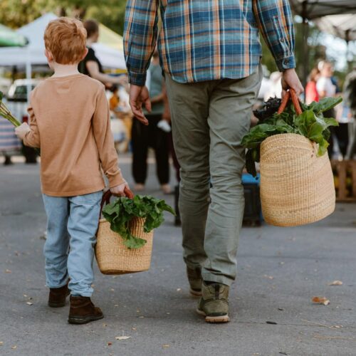 Father and Son in a market with shopping totes