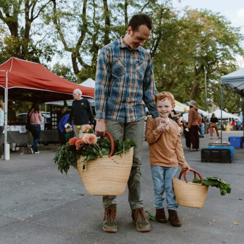 Happy Father and Son in a Market with shopping totes