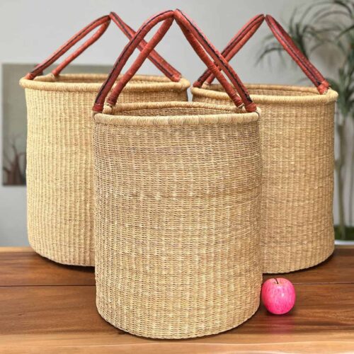 Set of Three Natural Woven Laundry Baskets next to an apple