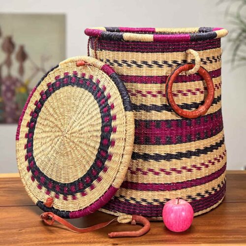 Colorful laundry basket with lid next to an apple