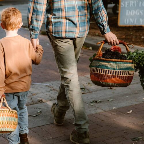 Father and Son outdoors with African market basket