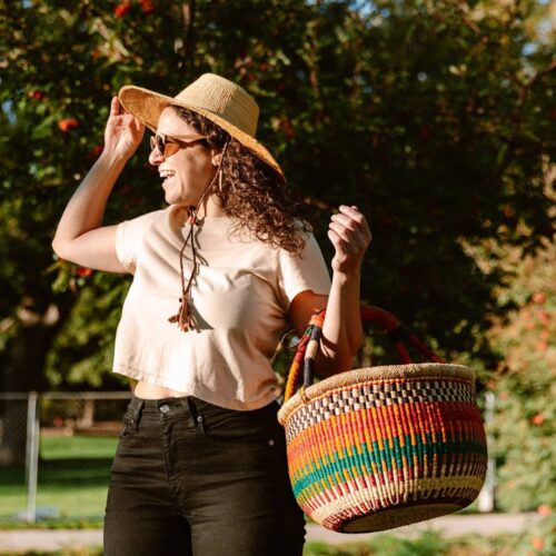 Woman outdoors with a Colorful Round African market basket