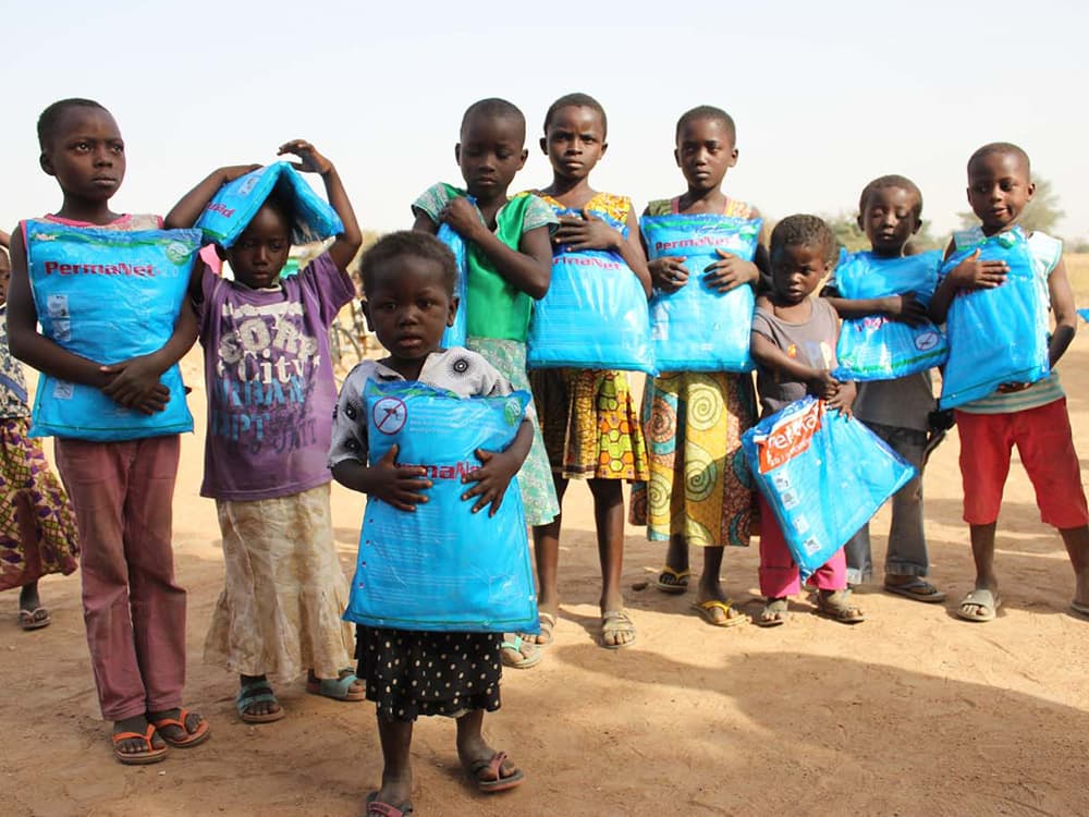 Kids in Africa receiving new Mosquito Nets